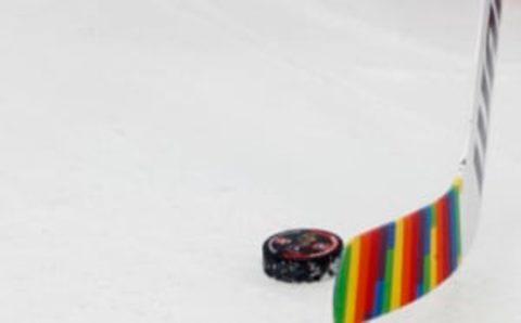 Jan 17, 2023; Washington, District of Columbia, USA; Washington Capitals goaltender Darcy Kuemper (35) handles a puck during warmup with rainbow stick tape in recognition of Pride Night prior to their game against the Minnesota Wild at Capital One Arena. Mandatory Credit: Geoff Burke-USA TODAY Sports