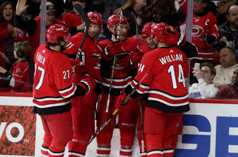 RALEIGH, NC – MARCH 28: Warren Foegele #13 of the Carolina Hurricanes celebrates with teammates Justin Williams #14, Justin Faulk #27, Jordan Staal #11 and Brett Pesce #22 after scoring a goal of during an NHL game against the Washington Capitals on March 28, 2019 at PNC Arena in Raleigh, North Carolina. (Photo by Gregg Forwerck/NHLI via Getty Images)