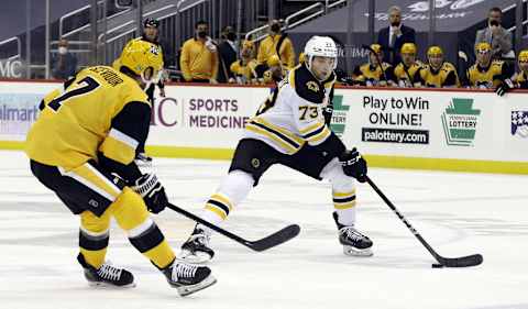 Mar 16, 2021; Pittsburgh, Pennsylvania, USA; Boston Bruins defenseman Charlie McAvoy (73) skates with the puck against Pittsburgh Penguins center Colton Sceviour (7) during the second period at PPG Paints Arena. Boston won 2-1. Mandatory Credit: Charles LeClaire-USA TODAY Sports