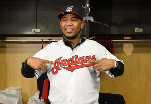 Jan 5, 2017; Cleveland, OH, USA; Cleveland Indians newly acquired player Edwin Encarnacion puts on his new jersey during a press conference at Progressive Field. Mandatory Credit: Ken Blaze-USA TODAY Sports