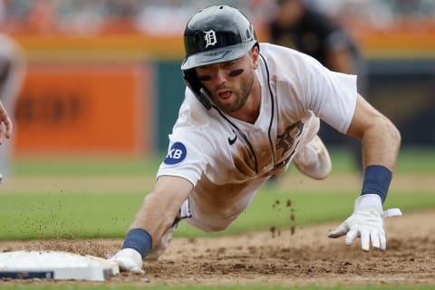 Jul 6, 2022; Detroit, Michigan, USA; Detroit Tigers second baseman Kody Clemens (21) dives back to first during the sixth inning against the Cleveland Guardians at Comerica Park. Mandatory Credit: Rick Osentoski-USA TODAY Sports