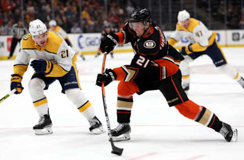 ANAHEIM, CALIFORNIA – MARCH 21: Isac Lundestrom #21 of the Anaheim Ducks shoots the puck past the defense of Nick Cousins #21 of the Nashville Predators during the first period of a game at Honda Center on March 21, 2022 in Anaheim, California. (Photo by Sean M. Haffey/Getty Images)