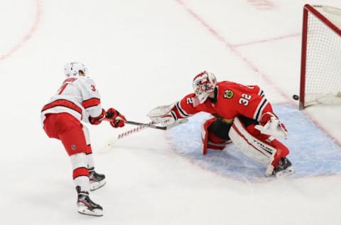 Feb 2, 2021; Chicago, Illinois, USA; Carolina Hurricanes right wing Andrei Svechnikov (37) scores a goal against Chicago Blackhawks goaltender Kevin Lankinen (32) during a shoot-out at United Center. Mandatory Credit: Kamil Krzaczynski-USA TODAY Sports