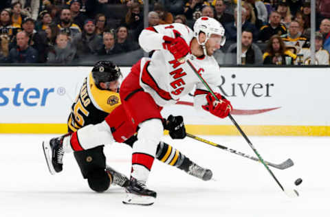 BOSTON, MA – DECEMBER 03: Boston Bruins right defenseman Brandon Carlo (25) breaks up the shot from Carolina Hurricanes center Jordan Staal (11) during a game between the Boston Bruins and the Carolina Hurricanes on December 3, 2019, at TD garden in Boston, Massachusetts. (Photo by Fred Kfoury III/Icon Sportswire via Getty Images)