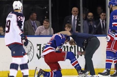 NEW YORK, NEW YORK – OCTOBER 23: Filip Chytil #72 of the New York Rangers is injured and attended to by trainer Jim Ramsey during the first period against the Columbus Blue Jackets at Madison Square Garden on October 23, 2022, in New York City. (Photo by Bruce Bennett/Getty Images)