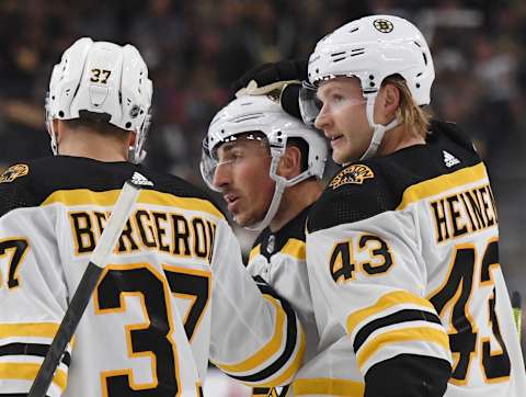 LAS VEGAS, NEVADA – OCTOBER 08: Patrice Bergeron #37, Brad Marchand #63 and Danton Heinen #43 of the Boston Bruins celebrate after Marchand scored a first-period power-play goal against the Vegas Golden Knights during their game at T-Mobile Arena on October 8, 2019 in Las Vegas, Nevada. (Photo by Ethan Miller/Getty Images)