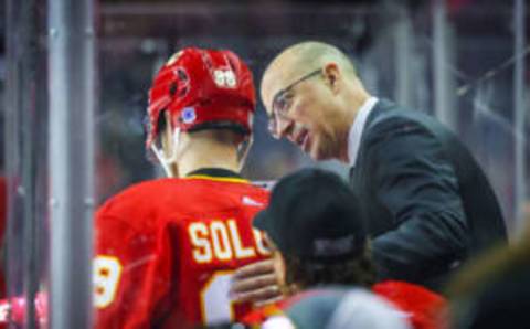 Sep 24, 2023; Calgary, Alberta, CAN; Calgary Flames head coach Ryan Huska talking to Calgary Flames defenseman Ilya Solovyov (98) on his bench against the Vancouver Canucks during the third period at Scotiabank Saddledome. Mandatory Credit: Sergei Belski-USA TODAY Sports