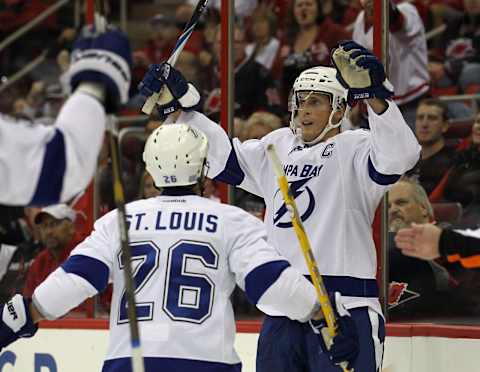 RALEIGH, NC – OCTOBER 07: Vincent Lecavalier #4 of the Tampa Bay Lightning scores a power play goal at 17:50 of the second period against the Carolina Hurricanes and is joined by Martin St. Louis #26 at the RBC Center on October 7, 2011 in Raleigh, North Carolina. (Photo by Bruce Bennett/Getty Images)