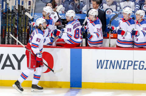 WINNIPEG, MB – FEBRUARY 12: Mika Zibanejad #93 of the New York Rangers celebrate a second period goal against the Winnipeg Jets with teammates at the bench at the Bell MTS Place on February 12, 2019 in Winnipeg, Manitoba, Canada. (Photo by Jonathan Kozub/NHLI via Getty Images)