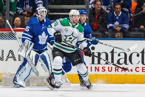 TORONTO, ON – MARCH 14: Travis Dermott #23 of the Toronto Maple Leafs battles for position against Jason Dickinson #16 of the Dallas Stars in front of James van Riemsdyk #25 during the second period at the Air Canada Centre on March 14, 2018 in Toronto, Ontario, Canada. (Photo by Kevin Sousa/NHLI via Getty Images)