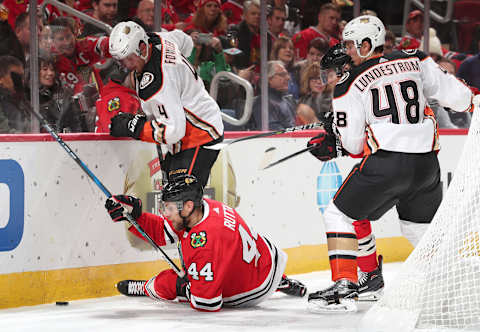 CHICAGO, IL – OCTOBER 23: Jan Rutta #44 of the Chicago Blackhawks falls next to Cam Fowler #4 of the Anaheim Ducks in the second period at the United Center on October 23, 2018, in Chicago, Illinois. (Photo by Chase Agnello-Dean/NHLI via Getty Images)