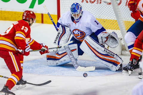 Feb 20, 2019; Calgary, Alberta, CAN; New York Islanders goaltender Thomas Greiss (1) makes a save as Calgary Flames left wing Johnny Gaudreau (13) tries to score during the first period at Scotiabank Saddledome. Mandatory Credit: Sergei Belski-USA TODAY Sports