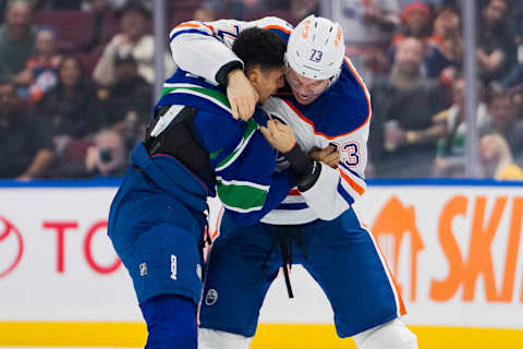 Oct 11, 2023; Vancouver, British Columbia, CAN; Edmonton Oilers defenseman Vincent Desharnais (73) fights with Vancouver Canucks forward Dakota Joshua (81) in the first period at Rogers Arena. Mandatory Credit: Bob Frid-USA TODAY Sports