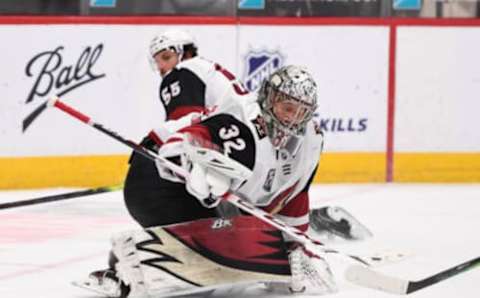 Mar 10, 2021; Denver, Colorado, USA; Arizona Coyotes goaltender Antti Raanta (32) deflects the puck in the third period against the Colorado Avalanche at Ball Arena. Mandatory Credit: Ron Chenoy-USA TODAY Sports