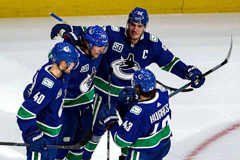 EDMONTON, ALBERTA – AUGUST 30: Tyler Toffoli #73 of the Vancouver Canucks is congratulated by his teammates after scoring a goal. (Photo by Bruce Bennett/Getty Images)