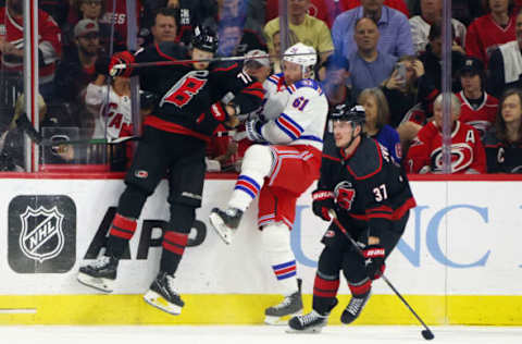 RALEIGH, NORTH CAROLINA – MAY 20: Steven Lorentz #78 of the Carolina Hurricanes checks Justin Braun #61 of the New York Rangers in Game Two of the Second Round of the 2022 Stanley Cup Playoffs at PNC Arena on May 20, 2022, in Raleigh, North Carolina. The Hurricanes shut out the Rangers 2-0. (Photo by Bruce Bennett/Getty Images)