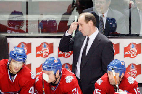 MONTREAL- MARCH 10: Montreal Canadiens head coach Bob Gainey watches play behind Maxim Lapierre #40, Gregory Stewart #70 and Glen Metropolit #15 during the game against the Edmonton Oilers at the Bell Centre on March 10, 2009 in Montreal, Quebec, Canada. The Canadiens defeated the Oilers 4-3 in overtime. (Photo by Richard Wolowicz/Getty Images)