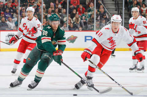 SAINT PAUL, MN – NOVEMBER 16: Jake Gardiner #51 of the Carolina Hurricanes defends Ryan Hartman #38 of the Minnesota Wild during the game at the Xcel Energy Center on November 16, 2019 in Saint Paul, Minnesota. (Photo by Bruce Kluckhohn/NHLI via Getty Images)