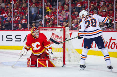 Calgary Flames goaltender Jacob Markstrom (25) guards his net as Edmonton Oilers center Leon Draisaitl (29) tries to score during the 2022 Stanley Cup Playoffs. Mandatory Credit: Sergei Belski-USA TODAY Sports