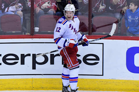 Dec 29, 2016; Glendale, AZ, USA; New York Rangers left wing Matt Puempel (12) celebrates after scoring his third goal of the game for a hat trick during the third period against the Arizona Coyotes at Gila River Arena. Mandatory Credit: Matt Kartozian-USA TODAY Sports