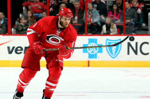 RALEIGH, NC – FEBRUARY 12: Tim Gleason #6 of the Carolina Hurricanes bats down an errant puck during an NHL game against the Anaheim Ducks during at PNC Arena on February 12, 2015 in Raleigh, North Carolina. (Photo by Gregg Forwerck/NHLI via Getty Images)