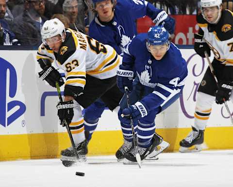 TORONTO, ON – OCTOBER 19: Brad Marchand #63 of the Boston Bruins battles against Trevor Moore #42 of the Toronto Maple Leafs during an NHL game at Scotiabank Arena on October 19, 2019 in Toronto, Ontario, Canada. The Maple Leafs defeated the Bruins 4-3 in overtime. (Photo by Claus Andersen/Getty Images)