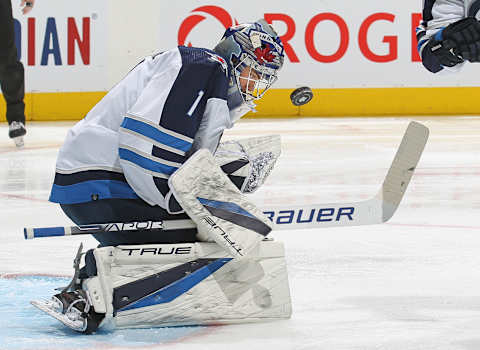 TORONTO, ON – MARCH 31: Eric Comrie #1 of the Winnipeg Jets makes a stop against the Toronto Maple Leafs during an NHL game at Scotiabank Arena on March 31, 2022 in Toronto, Ontario, Canada. The Maple Leafs defeated the Jets 7-3. (Photo by Claus Andersen/Getty Images)