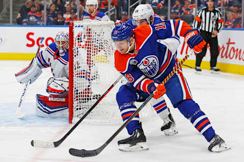 Oct 26, 2023; Edmonton, Alberta, CAN; New York Rangers defensemen Ryan Lindgren (55) tries to stop Edmonton Oilers forward Zach Hyman (18) from getting a shot on goaltender Jonathan Quick (32) during the third period at Rogers Place. Mandatory Credit: Perry Nelson-USA TODAY Sports