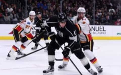 Mar 31, 2016; Los Angeles, CA, USA; Los Angeles Kings left wing Milan Lucic (17) and Calgary Flames defenseman T.J. Brodie (7) battle for the puck in the second period at Staples Center. Mandatory Credit: Kirby Lee-USA TODAY Sports