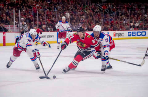 CHICAGO, IL – OCTOBER 25: Chicago Blackhawks center Dominik Kahun (24) controls the puck against New York Rangers defenseman Brady Skjei (76) and New York Rangers defenseman Marc Staal (18) during a game between the New York Rangers and the Chicago Blackhawks on October 25, 2018, at the United Center in Chicago, IL. (Photo by Patrick Gorski/Icon Sportswire via Getty Images)