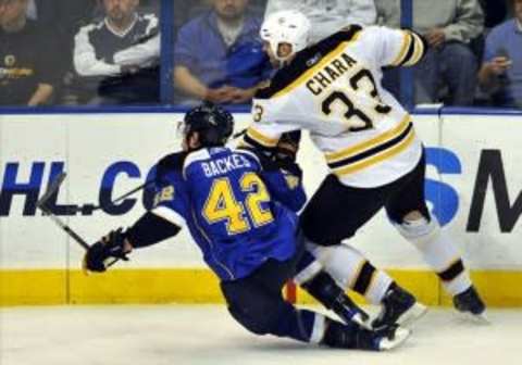 Nov 23, 2009; St. Louis, MO, USA; Boston Bruins defenseman Zdeno Chara (33) checks St. Louis Blues right wing David Backes (42) during the third period at the Scottrade Center. The Bruins defeated the Blues 4-2. Mandatory Credit: Scott Rovak-US PRESSWIRE