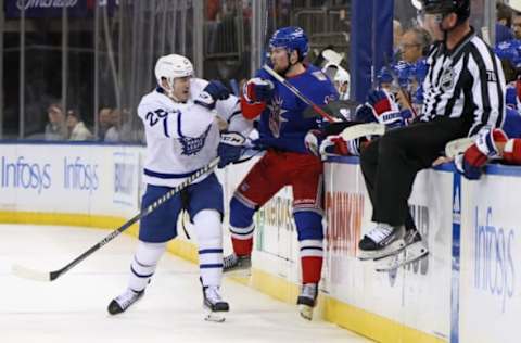 NEW YORK, NEW YORK – DECEMBER 15: Joey Anderson #28 of the Toronto Maple Leafs checks Alexis Lafreniere #13 of the New York Rangers during the second period at Madison Square Garden on December 15, 2022, in New York City. (Photo by Bruce Bennett/Getty Images)