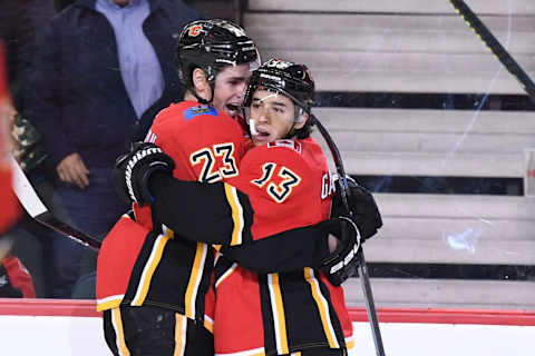 Dec 5, 2019; Calgary, Alberta, CAN; Calgary Flames left wing Johnny Gaudreau (13) celebrates with center Sean Monahan (23) after scoring a goal in the first period against the Buffalo Sabres at Scotiabank Saddledome. Mandatory Credit: Candice Ward-USA TODAY Sports