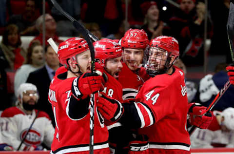 RALEIGH, NC – MARCH 24: Trevor van Riemsdyk #57 of the Carolina Hurricanes scores a game tying goal and celebrates with teammates Lucas Wallmark #71, Jordan Martinook #48 and Calvin de Haan #44 during an NHL game against the Montreal Canadiens on March 24, 2019 at PNC Arena in Raleigh, North Carolina. (Photo by Gregg Forwerck/NHLI via Getty Images)