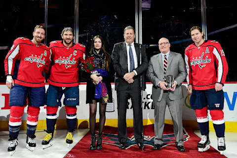 WASHINGTON, DC – APRIL 05: Alex Ovechkin #8 of the Washington Capitals stands with Brooks Orpik #44, his wife Nastya Ovechkina, Capitals president Dick Patrick, NHL Deputy Commissioner Bill Daly, and Nicklas Backstrom #19 during a pre-game ceremony honoring Ovechkin for playing in his 1,000th NHL game on April 1 against the Pittsburgh Penguins before a game against the Nashville Predators at Capital One Arena on April 5, 2018 in Washington, DC. (Photo by Patrick McDermott/NHLI via Getty Images)