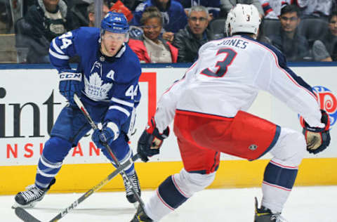 Morgan Rielly #44 of the Toronto Maple Leafs looks to make a play against Seth Jones #3 of the Columbus Blue Jackets(Photo by Claus Andersen/Getty Images)