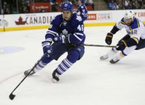 Jan 2, 2016; Toronto, Ontario, CAN; Toronto Maple Leafs defenceman Roman Polak (46) controls the puck against St. Louis Blues forward David Backes (42) during the first period at the Air Canada Centre. Mandatory Credit: John E. Sokolowski-USA TODAY Sports