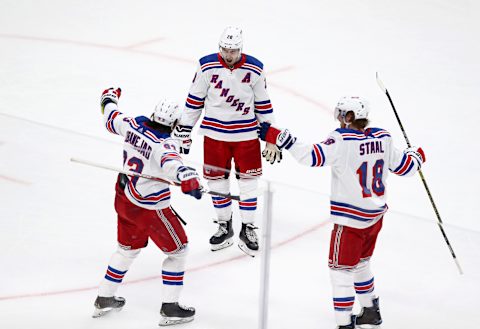 Chris Kreider and Marc Staal celebrate with Mika Zibanejad of the New York Rangers after Zibanejad scored a goal against the San Jose Sharks at SAP Center on December 12, 2019.