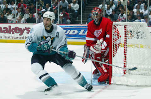 ANAHEIM, CA: Goaltender Curtis Joseph #31 of the Detroit Red Wings hugs the post as Steve Rucchin #20 of the Mighty Ducks of Anaheim waits for a pass during round one of the NHL 2003 Stanley Cup playoffs on April 14, 2003. (Photo by Donald Miralle/Getty Images/NHLI)