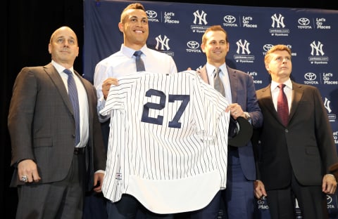 ORLANDO, FL – DECEMBER 11: General Manager Brian Cashman, Giancarlo Stanton, Manager Aaron Boone and owner Hal Steinbrenner of the New York Yankees pose for a photo after Stanton is introduced as a Yankees during a press conference at the 2017 Winter Meetings at the Walt Disney World Swan and Dolphin Resort on Monday, December 11, 2017 in Orlando, Florida. (Photo by Alex Trautwig/MLB Photos via Getty Images)