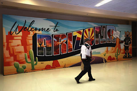 A fan of the Arizona Coyotes walks past a “Welcome to Arizona” sign during the first period of the NHL game against the Nashville Predators at Gila River Arena on April 29, 2022 in Glendale, Arizona. (Photo by Christian Petersen/Getty Images)