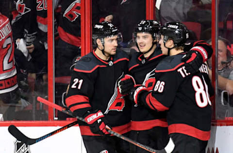 RALEIGH, NORTH CAROLINA – APRIL 22: Teuvo Teravainen #86 celebrates with Nino Niederreiter #21 and Sebastian Aho #20 of the Carolina Hurricanes after scoring a goal against the Washington Capitals in the second period of Game Six of the Eastern Conference First Round during the 2019 NHL Stanley Cup Playoffs at PNC Arena on April 22, 2019 in Raleigh, North Carolina. (Photo by Grant Halverson/Getty Images)