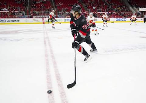 Jan 24, 2016; Raleigh, NC, USA; Carolina Hurricanes forward Victor Rask (49) skates with the puck against the Calgary Flames at PNC Arena. The Hurricanes defeated the Flames 5-2. Mandatory Credit: James Guillory-USA TODAY Sports