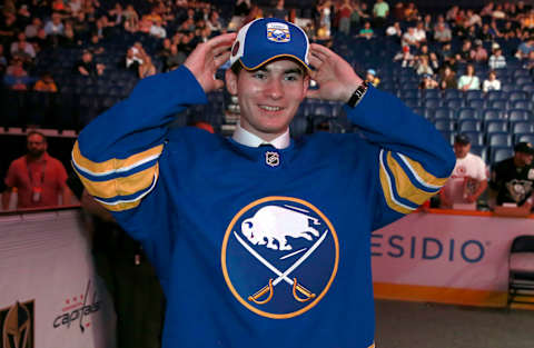 NASHVILLE, TENNESSEE – JUNE 29: Scott Ratzlaff puts on a hat after being selected 141st overall by the Buffalo Sabres during the 2023 Upper Deck NHL Draft at Bridgestone Arena on June 29, 2023 in Nashville, Tennessee. (Photo by Jeff Vinnick/NHLI via Getty Images)