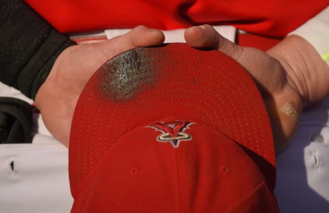 ANAHEIM, CA – JUNE 22: A detailed view of a Los Angeles Angels of Anaheim hat covered with pine tar held by Kole Callhoun #56 during the national anthem before the game against the Houston Astros at Angel Stadium of Anaheim on June 22, 2015 in Anaheim, California. (Photo by Matt Brown/Angels Baseball LP/Getty Images)