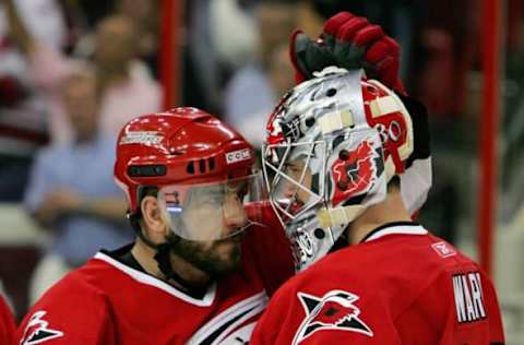 RALEIGH, NC – MAY 22: Cam Ward #30 and Mark Recchi #18 of the Carolina Hurricanes celebrate after defeating the Buffalo Sabres in game two of the Eastern Conference Finals during the 2006 NHL Playoffs May 22, 2006, at the RBC Center in Raleigh, North Carolina. The Hurricanes defeated the Sabres 4-3 to tie the series at one. (Photo by Jim McIsaac/Getty Images)