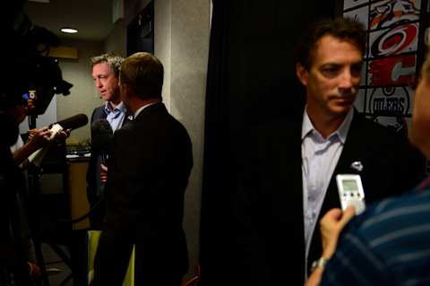 DENVER, CO – JULY 1: Colorado Avalanche head coach Patrick Roy gives an interview as director of hockey operations Joe Sakic speaks with the media in the foreground during a press conference to welcome Nathan MacKinnon, the number one overall pick in the 2013 NHL draft. MacKinnon, a native of Nova Scotia, addressed the media at the Pepsi Center. (Photo by AAron Ontiveroz/The Denver Post via Getty Images)