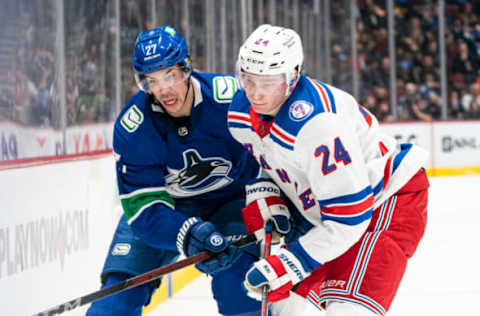 VANCOUVER, BC – NOVEMBER 2: Kaapo Kakko #24 of the New York Rangers ties up Travis Hamonic #27 of the Vancouver Canucks during NHL action on November 2, 2021, at Rogers Arena in Vancouver, British Columbia, Canada. (Photo by Rich Lam/Getty Images)