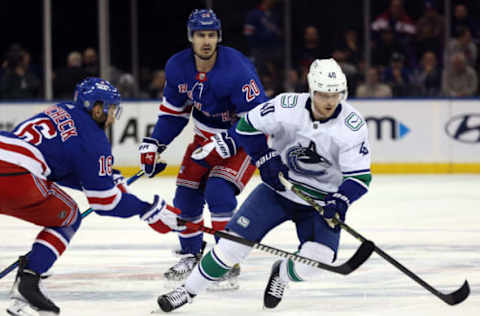 NEW YORK, NEW YORK – FEBRUARY 08: Vincent Trocheck #16 of the New York Rangers and Elias Pettersson #40 of the Vancouver Canucks battle for the puck during the game at Madison Square Garden on February 08, 2023, in New York City. (Photo by Jamie Squire/Getty Images)