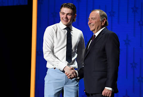 Jun 28, 2023; Nashville, Tennessee, USA; Buffalo Sabres draft pick Zach Benson shakes hands with NHL commissioner Gary Bettman after being selected with the thirteenth pick in round one of the 2023 NHL Draft at Bridgestone Arena. Mandatory Credit: Christopher Hanewinckel-USA TODAY Sports